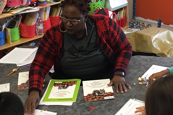 teacher helping kids