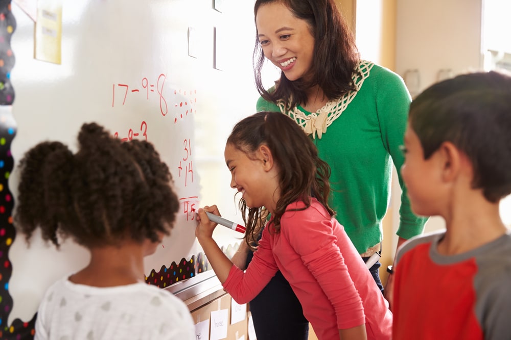 Photo - Teacher with students doing math